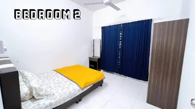 a bedroom with a bed and a blue curtain at HomeSTAY D'Manjung Lumut in Lumut