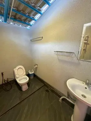 a bathroom with a toilet and a sink at Gold Crest Cameron Highlands in Tanah Rata