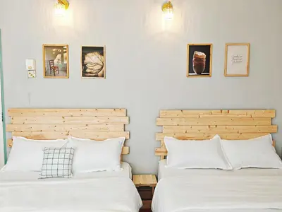 two beds sitting next to each other in a bedroom at HT Homestay BigSemi-D BBQwedding in town in Jelutong