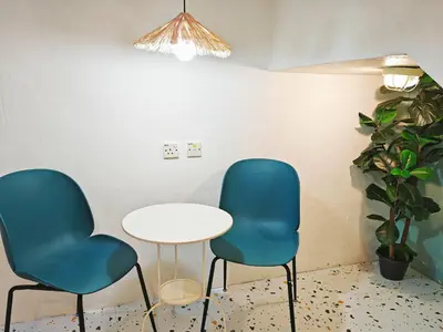 two chairs and a table in a waiting room at HT Homestay BigSemi-D BBQwedding in town in Jelutong