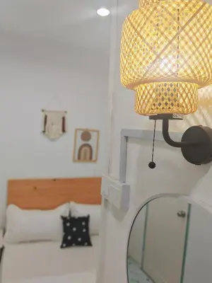 a lamp on top of a mirror in a bedroom at HT Homestay BigSemi-D BBQwedding in town in Jelutong