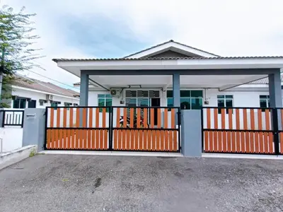 a house with an orange gate in front of it at HomeSTAY TAMAN MANJUNG POINT LUMUT PERAK in Lumut