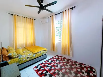 a bedroom with a bed and a ceiling fan at HomeSTAY TAMAN MANJUNG POINT LUMUT PERAK in Lumut
