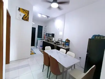 a dining room with a white table and chairs at HomeSTAY TAMAN MANJUNG POINT LUMUT PERAK in Lumut