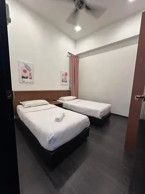 a room with two beds and a ceiling fan at Adamhawa Homestay 2 Nova Cameron Highlands in Brinchang