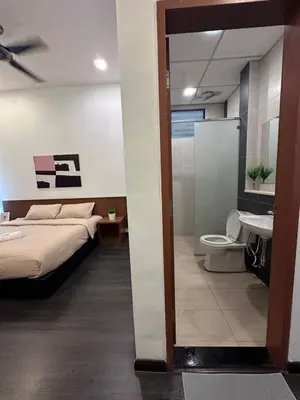 a bedroom with a bed and a toilet and a sink at Adamhawa Homestay 2 Nova Cameron Highlands in Brinchang