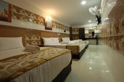 a hotel room with two beds and a kitchen at Cameron Kea Farm Hotel in Brinchang