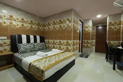 a bedroom with a bed and a table in a room at Cameron Kea Farm Hotel in Brinchang