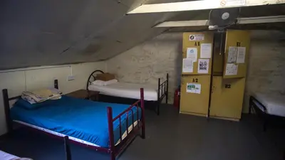 a room with two bunk beds in a building at Jungle Ippie Hostel in Tanah Rata