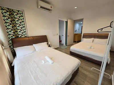 a hotel room with two beds and a mirror at The Octagon Ipoh City Centre Leisure Suite in Ipoh