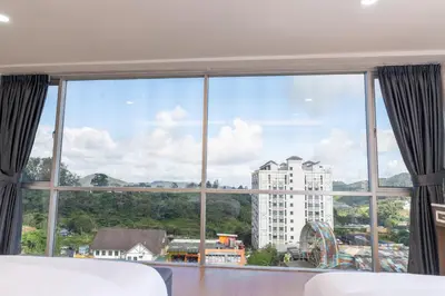 a large window with a view of a city at Sunrisestay in Brinchang