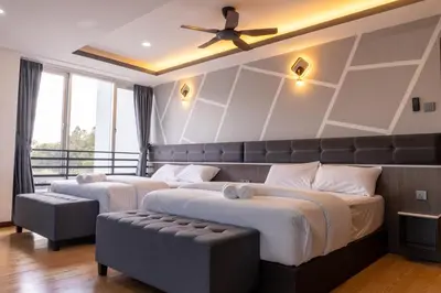 a bedroom with two beds and a ceiling fan at Sunrisestay in Brinchang