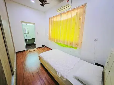 a bedroom with a bed with a yellow curtain and a window at 90 Home4Stay 2storeySemi-D gurney&beach Shopping local food in Tanjung Bungah