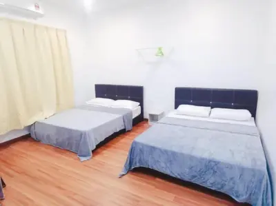 two beds sitting in a room with wood floors at 90 Home4Stay 2storeySemi-D gurney&beach Shopping local food in Tanjung Bungah
