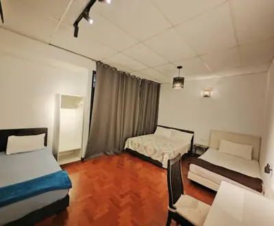a room with two beds and a couch in it at 12 George town 6room terrace gurney heritage adventist hospital restaurant shopping mall in George Town