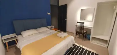 a bedroom with a bed and a desk and a chair at 12 George town 6room terrace gurney heritage adventist hospital restaurant shopping mall in George Town