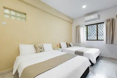 two beds in a room with white walls and a window at 35 Home4Stay Tanjong Bungalow Wedding BBQ Near Beach restaurant in Tanjung Bungah