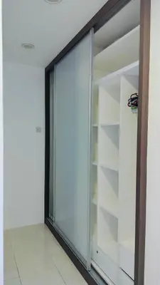 a sliding glass door in a room with shelves at Nyaman Sweet Home in Balik Pulau