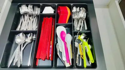 a drawer full of utensils in a box at Nyaman Sweet Home in Balik Pulau