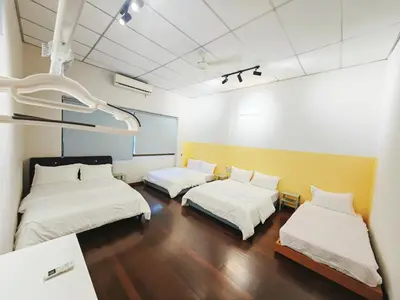 two beds in a room with white walls and wood floors at 7 Home4Stay Peaceful GurneyTerrace 4BR15pax Shops & Eateries in George Town