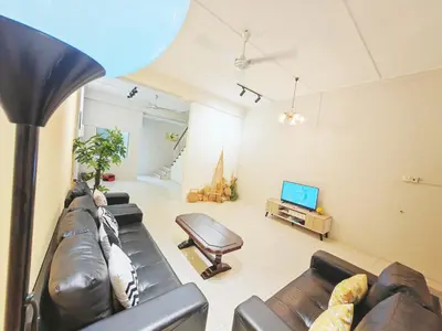 a living room with a leather couch and a television at 7 Home4Stay Peaceful GurneyTerrace 4BR15pax Shops & Eateries in George Town