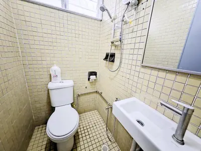 a bathroom with a toilet and a sink at 7 Home4Stay Peaceful GurneyTerrace 4BR15pax Shops & Eateries in George Town