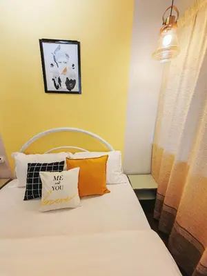 a bedroom with a bed with pillows on it at 7 Home4Stay Peaceful GurneyTerrace 4BR15pax Shops & Eateries in George Town