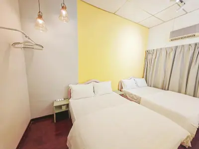 a room with two beds and a window at 7 Home4Stay Peaceful GurneyTerrace 4BR15pax Shops & Eateries in George Town