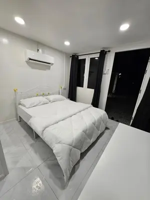 a bedroom with a large white bed in a room at Sentosa Palace in Dabung