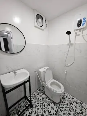 a bathroom with a sink and a toilet and a mirror at Sentosa Palace in Dabung
