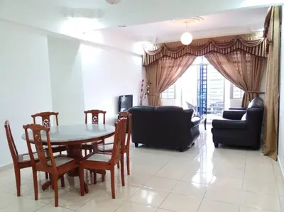 a living room with a table and chairs and a couch at Centrum Homestay in Cameron Highlands