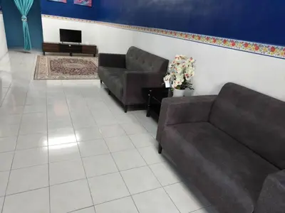 a living room with two couches and a tv at MyLittle Homestay in Tanjung Malim