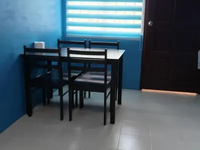 a table and chairs in a room with a window at MyLittle Homestay in Tanjung Malim