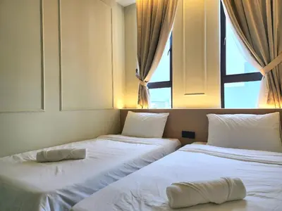 two beds in a room with a window at Georgetown AY Hotel in George Town