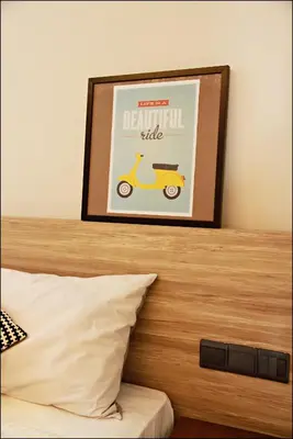 a picture of a scooter on top of a bed at U Hotel Penang in Bayan Lepas