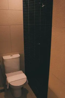 a bathroom with a toilet and a glass shower at U Hotel Penang in Bayan Lepas