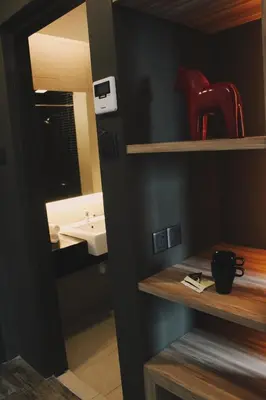 a bathroom with a sink and a mirror at U Hotel Penang in Bayan Lepas