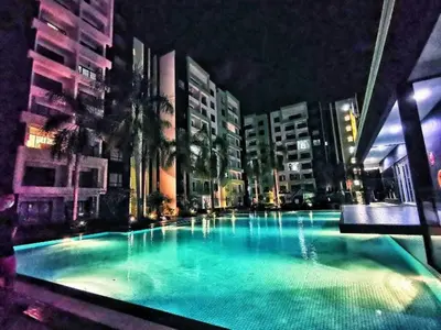 a large swimming pool in a city at night at 3R Guest House Manhattan Condominium in Ipoh