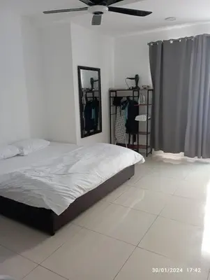 a bedroom with a bed and a ceiling fan at 3R Guest House Manhattan Condominium in Ipoh