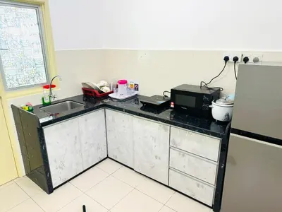 a kitchen with a counter with a sink and a microwave at Spice Arena Service Apartment in Bayan Lepas
