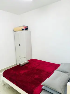 a bedroom with a bed with a red blanket on it at Spice Arena Service Apartment in Bayan Lepas