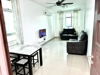 a living room with a table and a couch at Spice Arena Service Apartment in Bayan Lepas