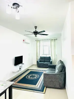 a living room with a couch and a tv at Spice Arena Service Apartment in Bayan Lepas