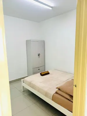 a bedroom with a bed in a white room at Spice Arena Service Apartment in Bayan Lepas