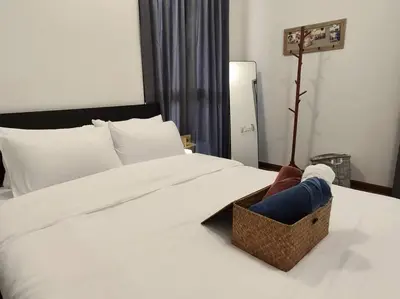 a person laying on a bed with a basket on it at SkyPool 2Br 8pax Premium Suites Beacon Georgetown Penang in George Town