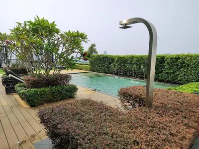 a swimming pool with a street light next to some bushes at SkyPool 2Br 8pax Premium Suites Beacon Georgetown Penang in George Town