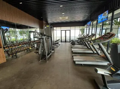 a gym with a row of treadmills and machines at SkyPool 2Br 8pax Premium Suites Beacon Georgetown Penang in George Town