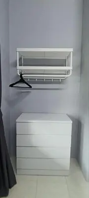 a white shelf above a white dresser in a room at Ipoh Garden East Homestay by Grab A Stay in Ipoh