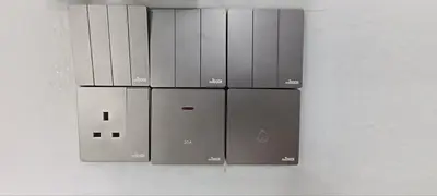 four servers are stacked on top of each other on a wall at Ipoh Garden East Homestay by Grab A Stay in Ipoh