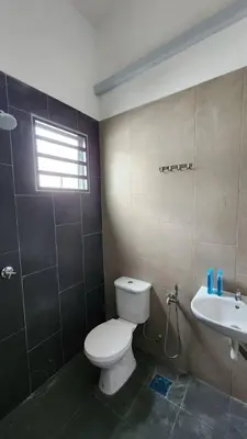 a bathroom with a toilet and a sink at Masturi Homestay in Chemor